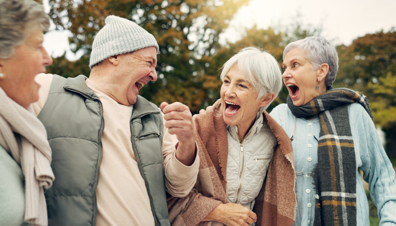 Golden Page | Friends, laughing and senior people in park for bonding, conversation and quality time together outdoors. Retirement, happy and elderly man and women in nature with funny joke, humor and happiness - 