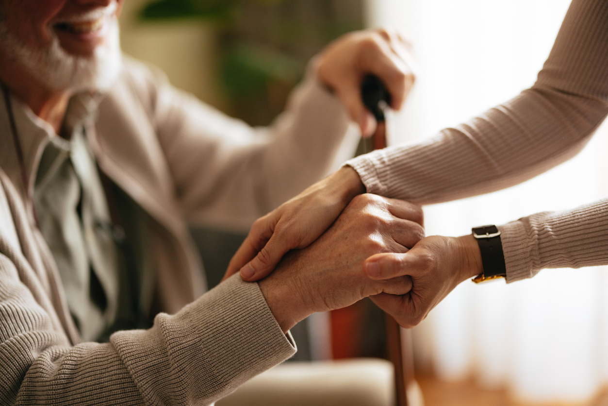 Close Up Photo Of Nurse Hands Holding A Hand Of A Senior Man At Nursing Home Golden Page | Close Up Photo Of Nurse Hands Holding A Hand Of A Senior Man At Nursing Home -