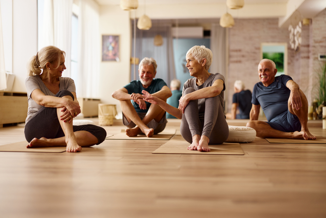 Happy athletic seniors talking on a break in a health club. Golden Page | Happy athletic seniors talking on a break in a health club. -